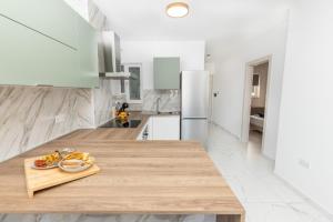 a kitchen with a wooden counter top with a plate of food at kensington in St. Paul's Bay