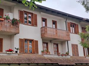 a building with wooden balconies and potted plants at My HOUSE in Roddino