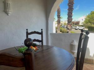 a wooden table and chair in a room with a window at AD house on Carvoeiro in Carvoeiro