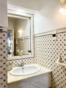 a bathroom with a sink and a large mirror at AD house on Carvoeiro in Carvoeiro