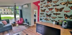 a living room with butterflies on the wall at Domek Hrabiny nr 3 in Rozkochów