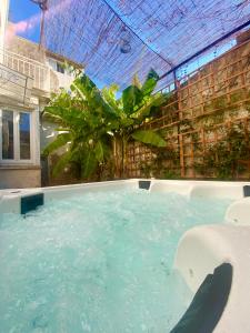 a large swimming pool with a roof at Maison de Maître L Oustal des Halles avec salle de cinéma, billard & Jacuzzi in Castelnaudary