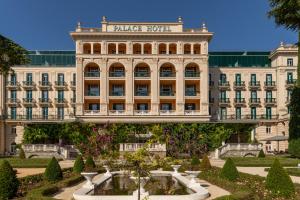 a hotel with a fountain in front of a building at Floating Sea House SHARK 3 in Portorož