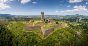 an old castle on top of a hill with a tower at A casa di Peppetto in Radicofani