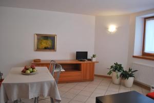 a living room with a table and a desk at Cadari' Appartamenti in Castel Condino +15 photos