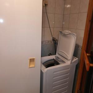 a washing machine sitting on top of a trash can at SuLevi Apartment in Levi +25 photos