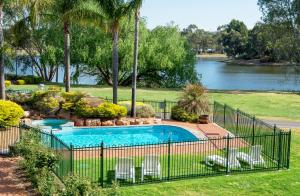 
a park with a pool and a fence at Clare Country Club in Clare
