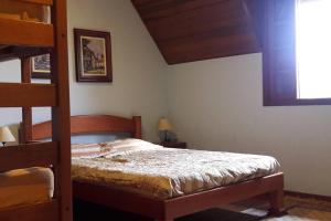 a bedroom with a bunk bed and a ladder at Casa e Vista privilegiadas no Alto do Capivari in Campos do Jordão