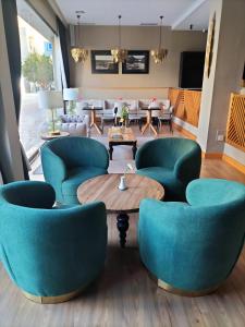 a lobby with blue chairs and a table at Hotel Torre Del Conde in San Sebastián de la Gomera