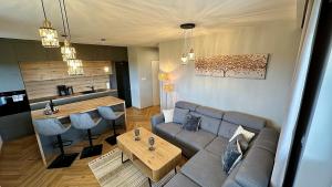 a living room with a couch and a table at Apartament Słoneczny in Łańcut