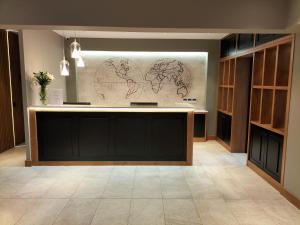 a lobby with a counter with a map on the wall at Hotel Torre Del Conde in San Sebastián de la Gomera