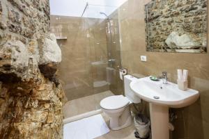 a bathroom with a white toilet and a sink at Guest House J.Prifti in Berat