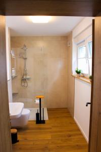 a bathroom with a white sink and a tub at Ferienwohnung Repetal in Attendorn