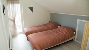 Ένα ή περισσότερα κρεβάτια σε δωμάτιο στο Vakantiehuis Oostendorp