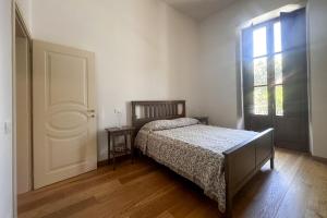 a bedroom with a bed and a window at La CASA al CENTRO in LʼAquila