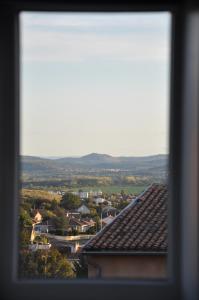 a view of a small town from a roof at Maison du vigneron Saint-Martin in Cournon-dʼAuvergne