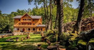a large wooden house in the middle of a forest at Willa Orle Gniazdo in Biała Woda
