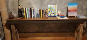 a wooden table with a bunch of books on it at BlueWave Surf Stay in San Isidro