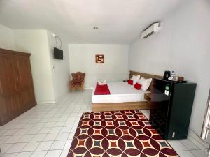 Postel nebo postele na pokoji v ubytování New Mekar Jaya Hotel + 37 fotografií