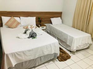 two beds with stuffed animals on them in a room at Hotel Bambú in Tailandia