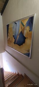 a painting hanging on a wall in a stairwell at olivegrove in Sidari