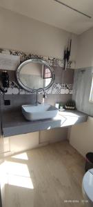 a bathroom with a sink and a mirror at olivegrove in Sidari