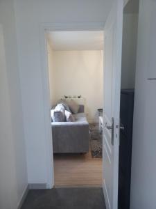 a room with a couch and a bed in it at Chambre privée Sdb kitchenette proche de Paris in Saint-Ouen