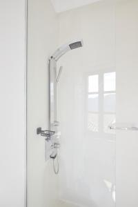 a shower with a faucet in a bathroom at Clock Tower Arachova in Arachova