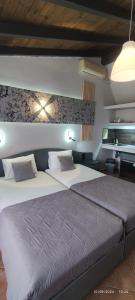 a bedroom with a large bed in a room at olivegrove in Sidari