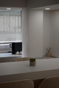 a room with a table and chairs and a window at La Perla Apartment in Taranto