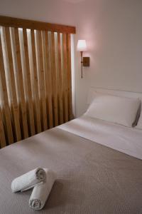 a towel laying on a bed in a bedroom at La Perla Apartment in Taranto