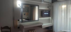 a bathroom with a sink and a mirror at olivegrove in Sidari