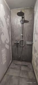 a shower in a corner of a bathroom at olivegrove in Sidari