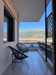 a balcony with chairs and a view of the ocean at Adagio, JIMA winery luxury apartments in Ioannina