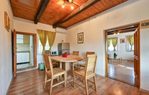 a kitchen and dining room with a table and chairs at 1 Bedroom Cozy Home In Blaskovec in Blaškovec