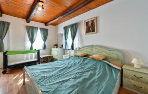 a bedroom with a bed and a television in it at 1 Bedroom Cozy Home In Blaskovec in Blaškovec +31 photos
