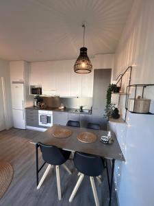 a kitchen with a table and chairs in a room at Luxurious Apartment in Rovaniemi