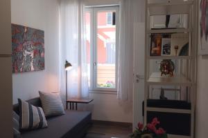 a living room with a couch and a window at Vikos Lodge Apartment in Bologna