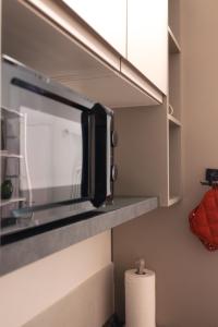 a kitchen with a microwave above a counter at Vikos Lodge Apartment in Bologna +14 photos
