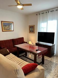 a living room with a couch and a coffee table at Casa Rural Oropesa in Villanueva del Ariscal