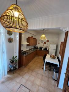 a kitchen with a table and two lights and a kitchen with a tableablish at Casa Rural Oropesa in Villanueva del Ariscal +7 photos