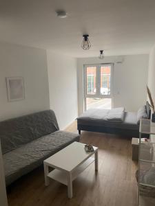 a living room with a couch and a table at 1 Zimmer Studio Apartment in Cologne +6 photos