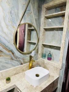 a bathroom with a sink and a mirror at RAIO DE LUZ GUARAPARI BEACH in Guarapari +24 photos