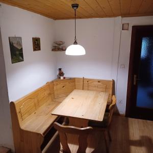 a wooden table and chairs in a room at Ferienhaus Benko in Hieflau