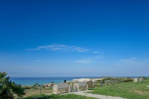 a person sitting at a table looking at the beach at B&B L'EDEN DI CAPO BIANCO in Montallegro