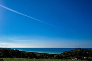 a view of the ocean from a hill at B&B L'EDEN DI CAPO BIANCO in Montallegro