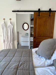 a bedroom with a bed and a dresser and a mirror at Biot - Place des Arcades in Biot