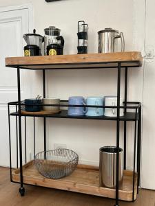 a wooden shelf with pots and pans on it at Biot - Place des Arcades in Biot +20 photos