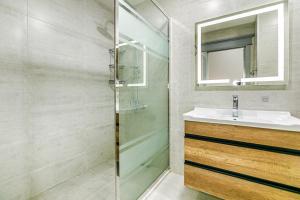 a bathroom with a sink and a shower at Pole Star apartment by Bea Paradise in Baku +41 photos