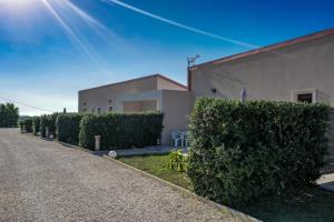 a house with bushes next to a building at B&B L'EDEN DI CAPO BIANCO in Montallegro